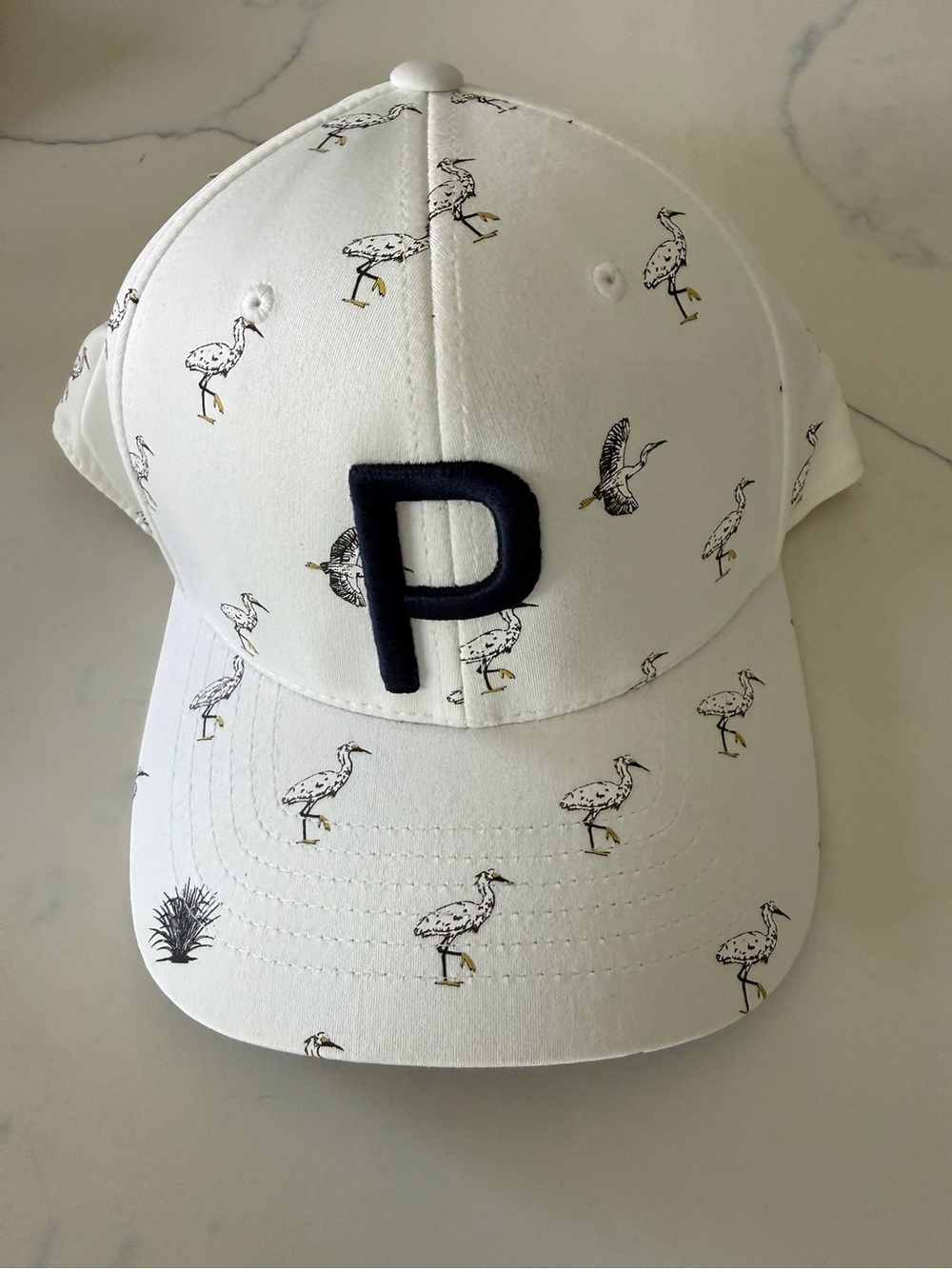 Puma White Cap with Navy P and Yellow-Accented Bird Print